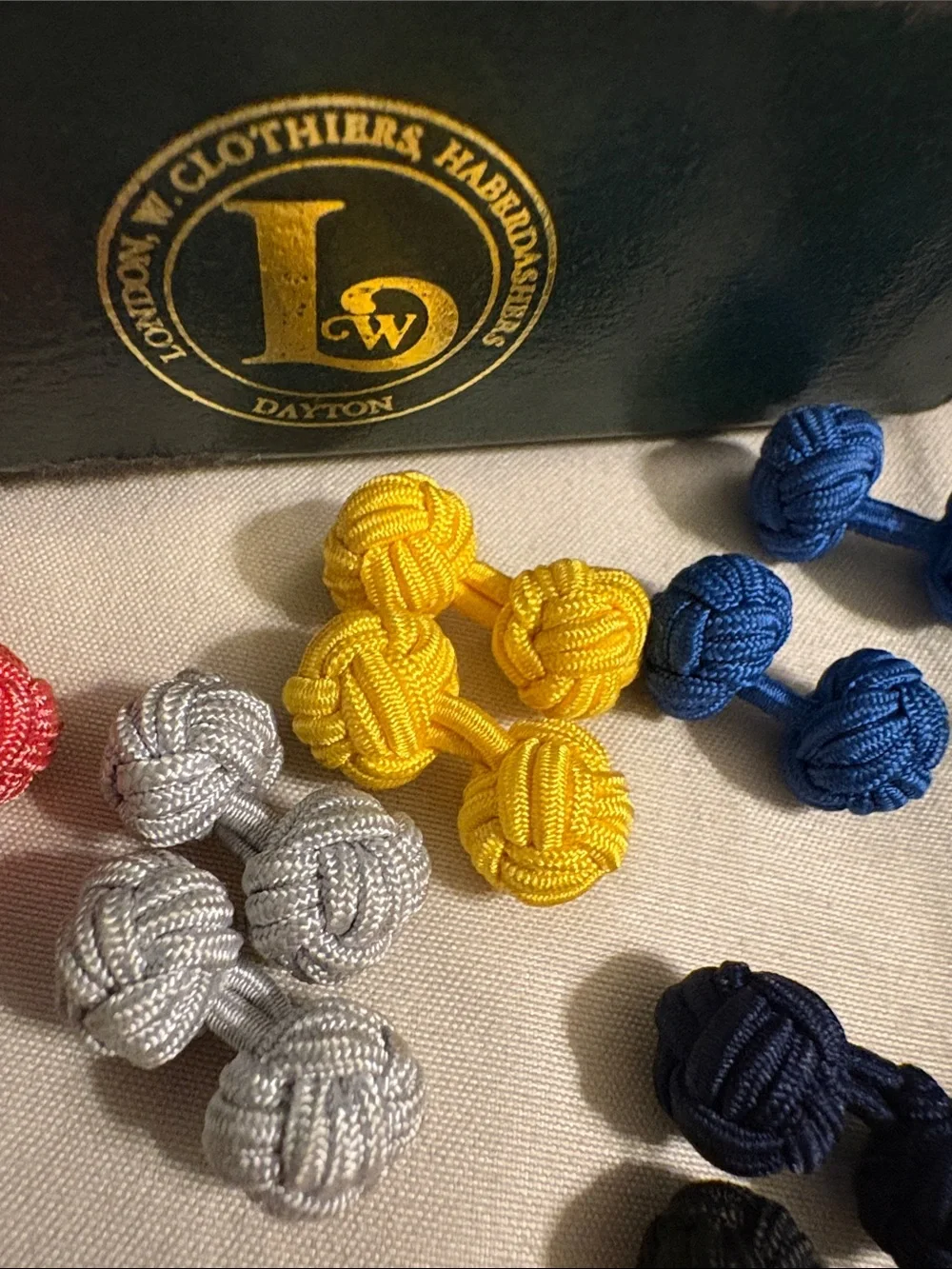 London W. Clothiers & Haberdashers vintage box & several silk knot cuff links